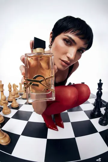 Produktwerbung für ein Parfum auf einem Schachbrett, Model mit rotem Handschuh
